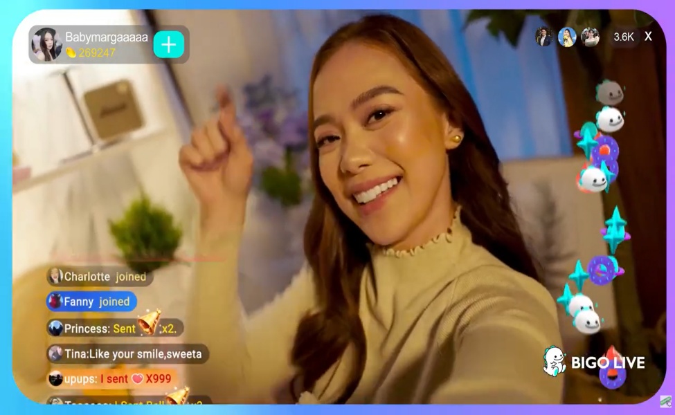 Woman smiling during BIGO Live stream with viewer interactions visible