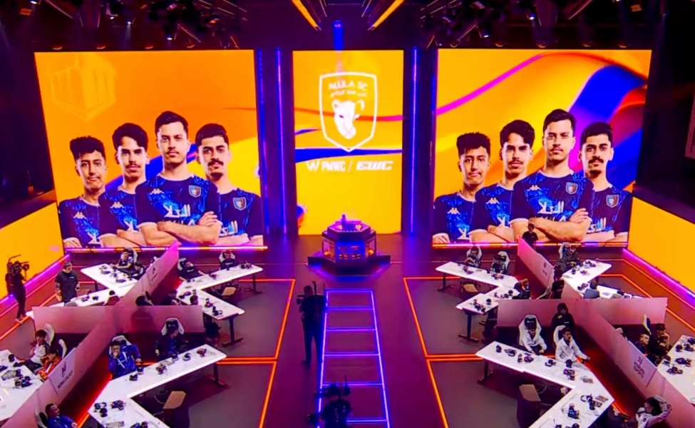 PMWC esports arena with team displayed on large LED screens