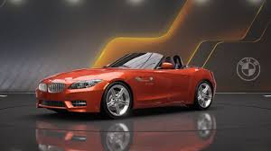 Red BMW Z4 sports car convertible displayed in showroom setting