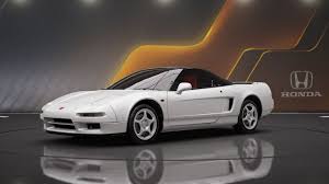 White Honda NSX sports car in showroom with reflection
