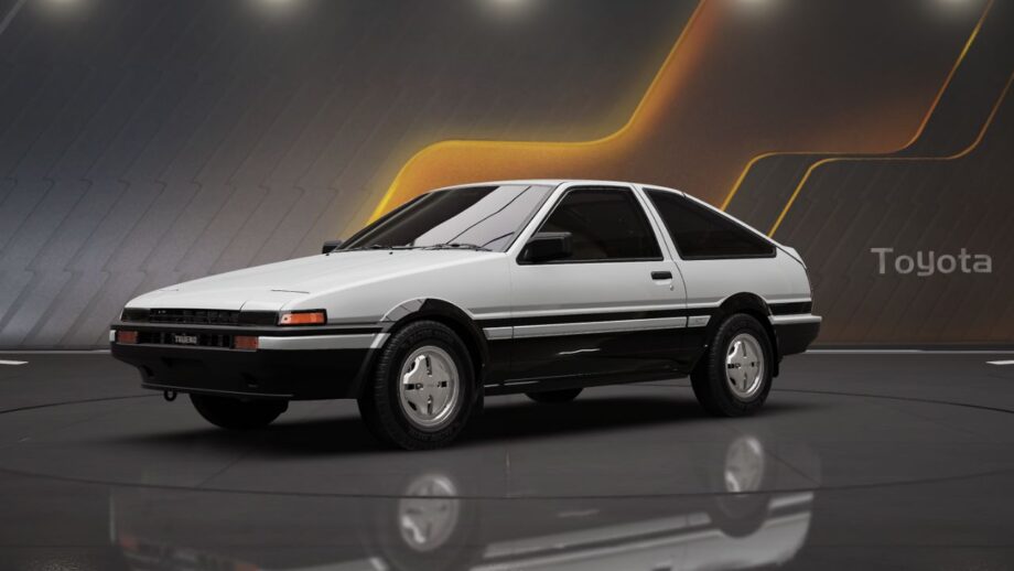 White and black Toyota AE86 Sprinter Trueno sports car in showroom setting