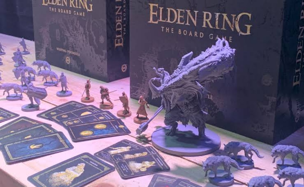 Elden Ring board game display with miniatures, game board, cards, and boss figure under purple