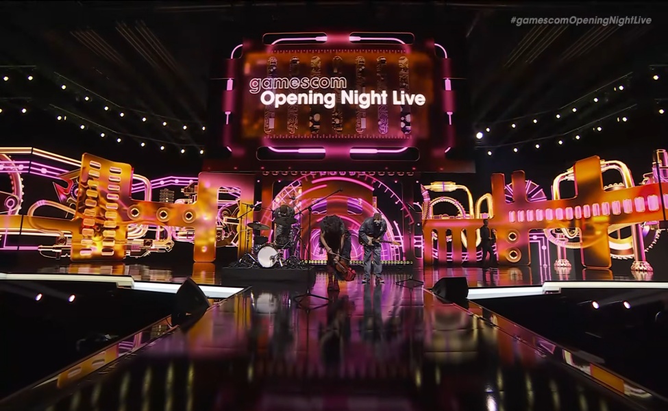 Gamescom Opening Night Live stage with neon pink and gold lighting and large display screens